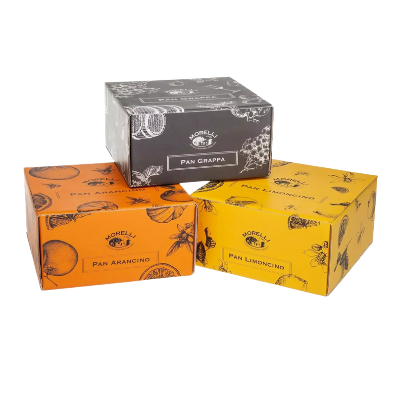 Trois boîtes de Panettone Morelli avec des saveurs Limoncino, Arancino et Grappa, présentées côte à côte.