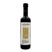 Face avant de la bouteille de vinaigre balsamique de Modène I.G.P. Carandini 500ml, avec étiquette blanche et dorée représentant une tour stylisée.