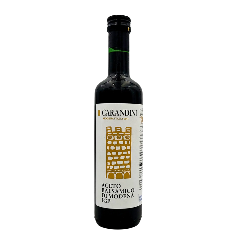 Face avant de la bouteille de vinaigre balsamique de Modène I.G.P. Carandini 500ml, avec étiquette blanche et dorée représentant une tour stylisée.