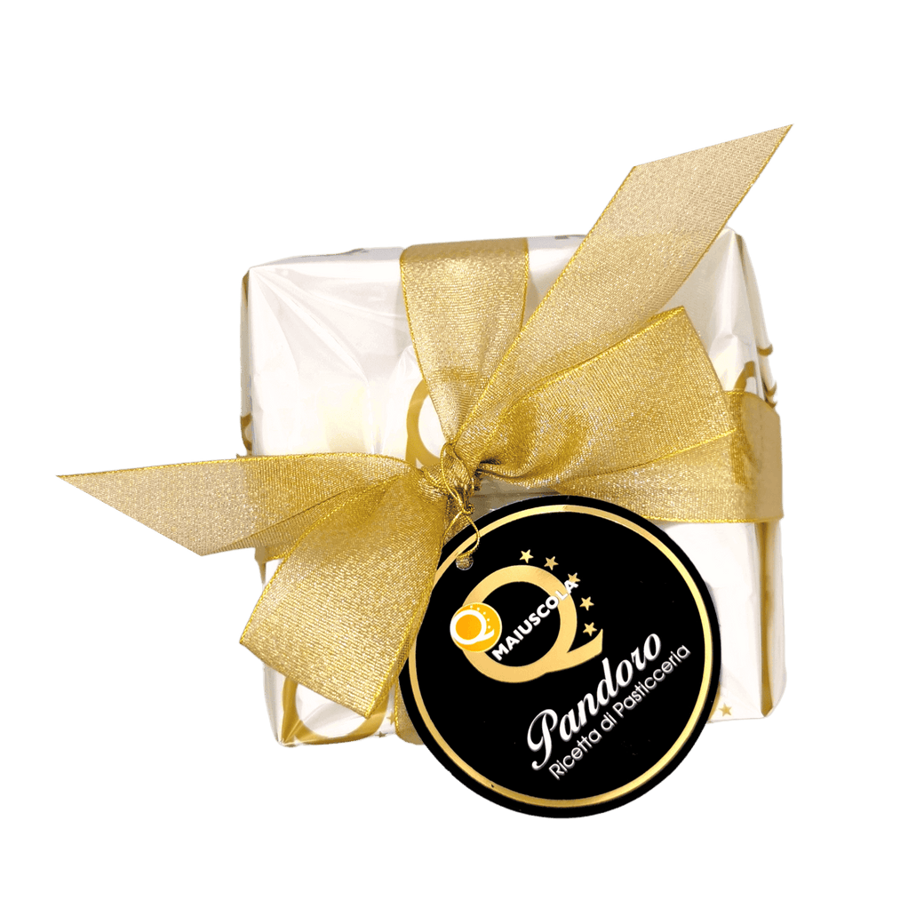 Hand-wrapped natural sourdough pandoro Q Maiuscola with a golden ribbon, 1kg, traditional Christmas dessert flavored with vanilla.